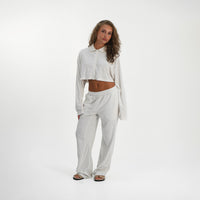 Model in a relaxed front pose wearing the Soft Towelling Top and straight-leg Trousers set in White