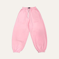 The Mani Joggers in Bubblegum Pink laid flat, showing the white drawstrings, elasticated waist and cuffed ankles
