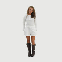 Model wearing the Seaside Henley Waffle Top in White with the matching shorts, full-length front view