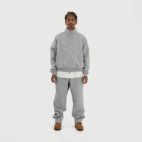 Model wearing the Everyday Zip Up in Grey with the matching joggers, full-length front view