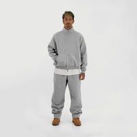 Model wearing the Everyday Joggers in Grey with the matching zip-up and a white tee, full-length front view