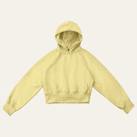 Cropped Hoodie in Butter Yellow laid flat from the front, showing the raglan sleeves, deep cuffs and ribbed hem